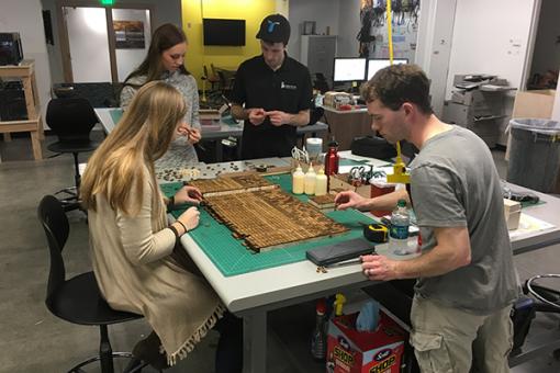 Students working with print top table.